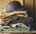 A brown hat sitting on top of a stack of jeans Royalty Free Stock Photo