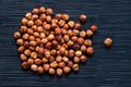 Brown hazelnut heap on dark background. Ripe hazel nut for food