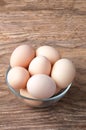 Brown Hen eggs in bowl on wooden table. Fresh farmer`s egg Royalty Free Stock Photo