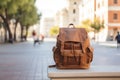 Brown hipster backpack on the bench in Spanish city old town square street. Solo traveler, tourism, travel, vacation Royalty Free Stock Photo