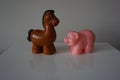 Brown horse and ping pig toys figures Royalty Free Stock Photo