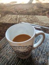 Brown Indian chai tea in white china cip top angle