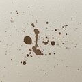 Brown ink splatters on textured white paper create an abstract pattern. The splatters Royalty Free Stock Photo