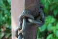 Brown iron chain on a rusty old pillar Royalty Free Stock Photo