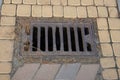 brown iron drain grate on pavement road Royalty Free Stock Photo