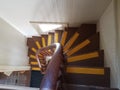 Brown irregular steps and banister and yellow lines in lighthouse staircase Royalty Free Stock Photo