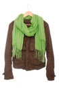 Brown jacket and green scarf are on hanger. Royalty Free Stock Photo