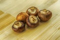 Brown king champignon large and whole lies on a wooden background Royalty Free Stock Photo