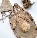 Brown knitted baby set of cap, booties and bodysuit Royalty Free Stock Photo