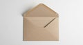 Brown kraft paper envelope with its flap open rests on a plain white surface. The Royalty Free Stock Photo