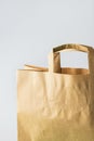 Brown kraft paper grocery shopping bag on white wall background. Plastic-free alternatives environmental protection Royalty Free Stock Photo