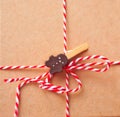 Brown kraft paper texture with striped ribbon and gingerbreadman clothpin for packaging or gift wrapping. Kraft paper texture