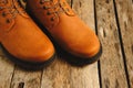 Brown, laced autumn boots on an old wooden, rustic background Royalty Free Stock Photo