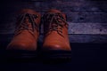 Brown, laced boots on an old wooden, rustic background Royalty Free Stock Photo