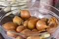 Brown large unpeeled onion in a glass bowl