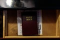 Brown leather bible and golden letters in drawer