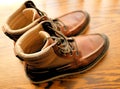 Brown Mens Leather Boots Fashionable on Wood Grain Royalty Free Stock Photo