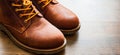 Leather boots shoes on the brown wooden table background.with copy space. Royalty Free Stock Photo