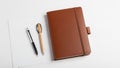 Brown leather bound notebook with an elastic closure placed on a white Royalty Free Stock Photo