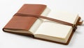 Leather bound notebook with tied strap closure lies open on a white Royalty Free Stock Photo