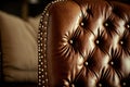brown leather chair with brass nail head detailing against white background