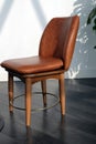 Brown leather chair on wooden legs close-up. Royalty Free Stock Photo