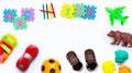 Brown leather children`s sandals with colorful  toys on white background. Royalty Free Stock Photo