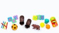 Brown leather children`s sandals with colorful  toys on white background. Royalty Free Stock Photo