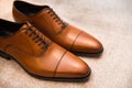 Brown leather classic male shoes on the floor