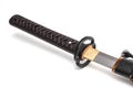 Brown leather cord tie on grip Japanese sword steel fitting and black scabbard. Royalty Free Stock Photo