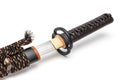 Brown leather cord tie on grip Japanese sword steel fitting and black scabbard. Royalty Free Stock Photo