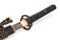 Brown leather cord tie on grip Japanese sword steel fitting and black scabbard. Royalty Free Stock Photo