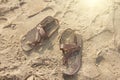Brown leather flip flops on the sand. Couple Royalty Free Stock Photo