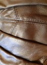 Brown leather fragment of clothing with seams. Background design, photography. Textile, fabric template, modern new Royalty Free Stock Photo