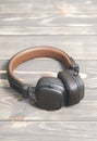 Brown Leather Headphones On Vintage Wooden Background. Modern Music Concept