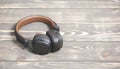 Brown Leather Headphones On Vintage Wooden Background. Modern Music Concept