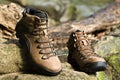 Brown leather hiking boot on wood. Royalty Free Stock Photo