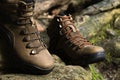 Brown leather hiking boot on wood. Royalty Free Stock Photo