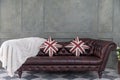 Brown leather Luxurious sofa with pillow and wool Royalty Free Stock Photo