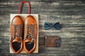 Brown leather men`s boots and accessories on a wooden background, top view Royalty Free Stock Photo