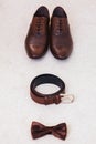 Brown leather men`s shoes with belt, bow-tie. Set groom accessories. Royalty Free Stock Photo