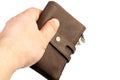 Brown leather men`s wallet in the hand. Wallet in the hand isolated above white background Royalty Free Stock Photo