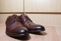 Brown leather men shoes on wooden ground Royalty Free Stock Photo