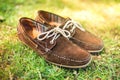 Brown leather mens shoes, elegant summer moccasins in grass. Men fashion, men accesories and footwear. Royalty Free Stock Photo