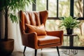 Brown leather mid-century wing chair near potted houseplants against window. Boho home interior design