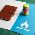 A brown leather notebook with a button closure lies on a white and green Royalty Free Stock Photo