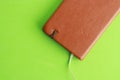 Brown leather notebook on a green surface Royalty Free Stock Photo