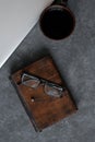 Brown leather notebook, pen, laptop and glasses on gray background Royalty Free Stock Photo