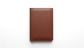 A brown leather notebook with a smooth texture lies on a white surface Royalty Free Stock Photo