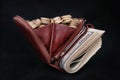 Brown leather purse full of coins and bank-paper Royalty Free Stock Photo